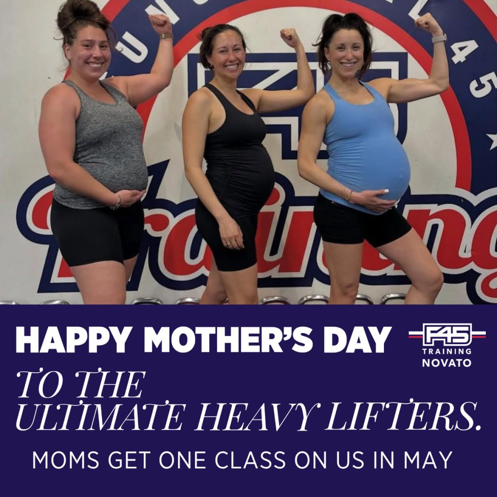 pregnant women making muscle arms at F45